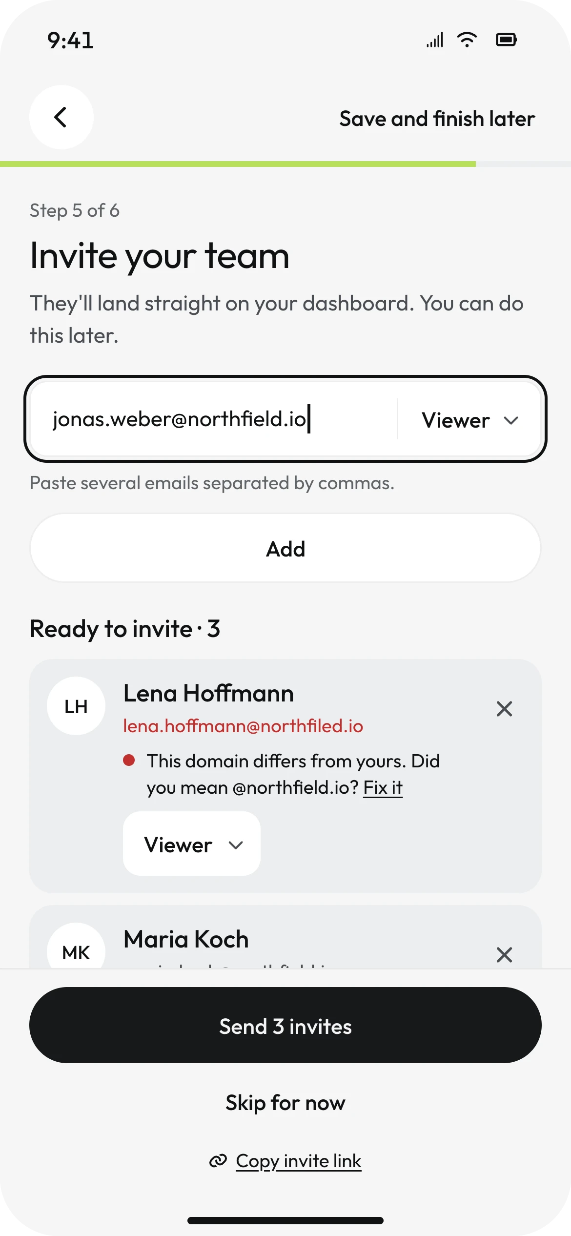 Mobile invite screen with the email field, Viewer as default role and Lena Hoffmann's row flagged: this domain differs from yours, did you mean @northfield.io, Fix it.